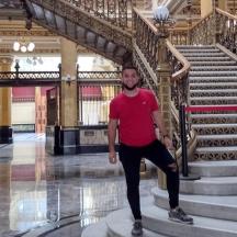 a man standing in front of a staircase in a building