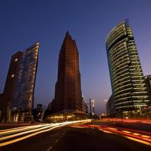 a group of tall buildings in a city at night