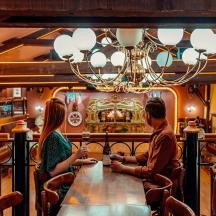 a man and woman sitting at a table in a restaurant