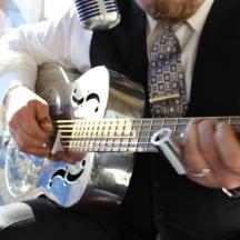 a man is playing a guitar with a microphone