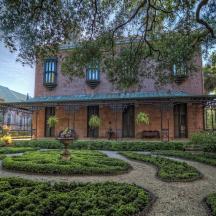 an exterior view of a house with a garden