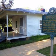 a small building with a sign in front of it