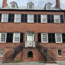 a large red brick building with a white door