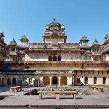a large building with benches in front of it