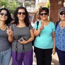 a group of women giving the peace sign