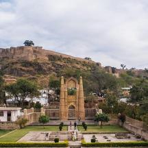 a view of a hill with a church and a park