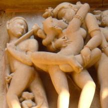 a statue of people on the side of a wall