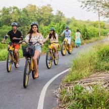 a group of people riding bikes down a road
