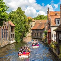a group of people riding in canoes down a canal