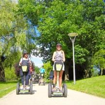 a group of people riding seicycles down a path