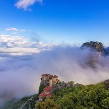 a castle on a mountain in the clouds