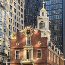 a brick building with a clock tower in a city