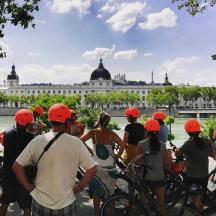 a group of people with bikes in front of a building