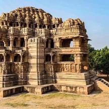 a large stone building sitting on top of a field