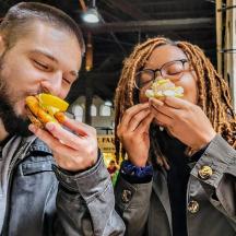 a man and a woman eating hot dogs