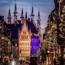 a city street with christmas lights and a building
