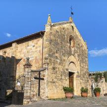 an old stone building with a church with a tower