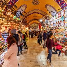 a crowd of people walking through a market in a store