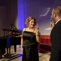 a man and a woman holding glasses of wine