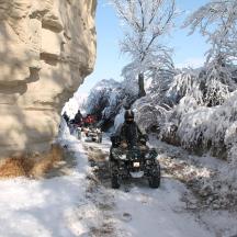 a group of people riding on a dirt bike in the snow