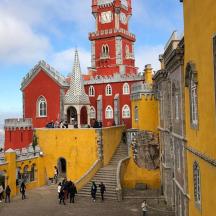 a red and yellow building with a clock tower
