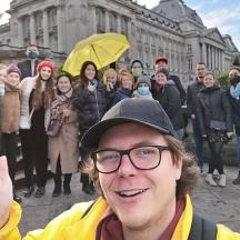 a man giving a thumbs up in front of a group of people