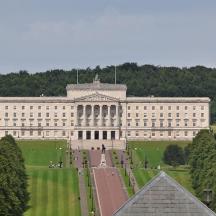 a large white building with trees in front of it