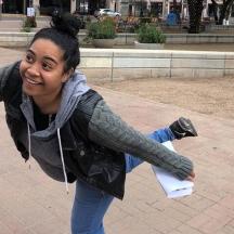 a woman is dancing with her arm in the air