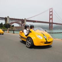 a group of people riding in a yellow car