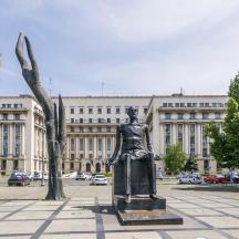 a statue of a woman in front of a building