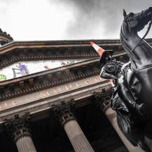 a statue of a horse in front of a building