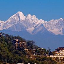 a mountain range with houses and mountains in the background