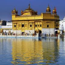 a large yellow building with water in front of it