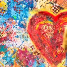 a man standing in front of a painting of a heart