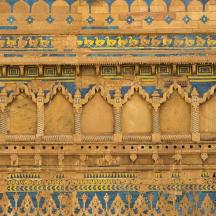 a stone wall with intricate designs on it
