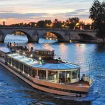 un vaixell que baixa per un riu prop d'un pont