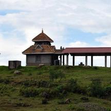 a building on top of a grassy hill