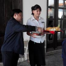 a man handing a woman a plate of food