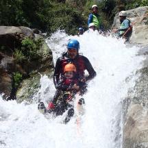 a group of people rafting in a waterfall