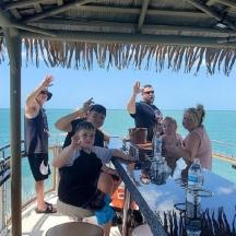 a group of people sitting at a table on a boat