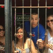a group of people standing behind a gate