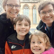 a family posing for a picture in front of a building