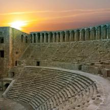 an empty amphitheater with the sunset in the background