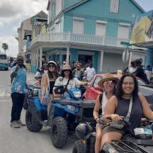 a group of people sitting in the back of a truck