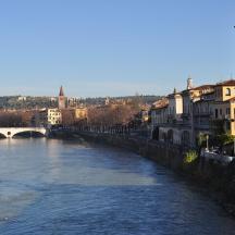 a river in a city with a bridge and buildings