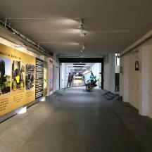 a hallway in a building with posters on the walls