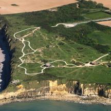 an aerial view of a cliff with the ocean