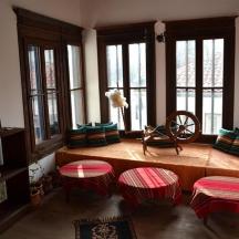 a living room with a bench and some windows