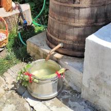 a bucket of water sitting next to a barrel