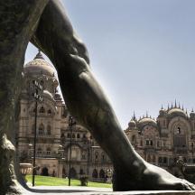 a statue in front of a large building